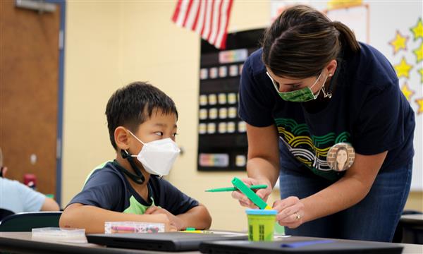 teacher helps student count blocks